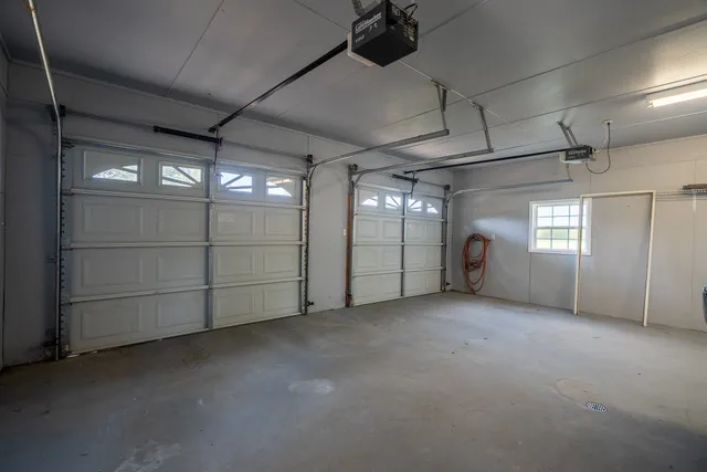 en empty room with windows and fireplace