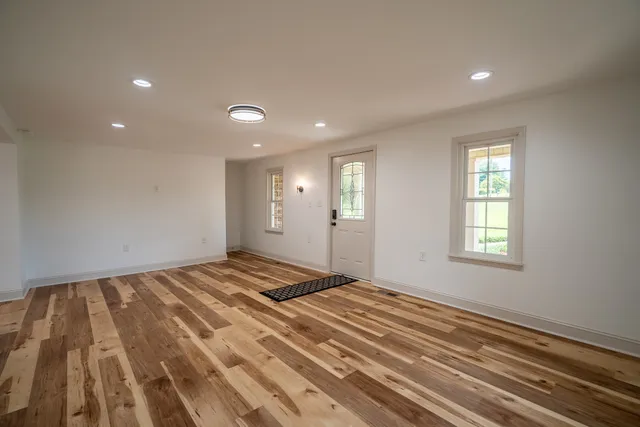 a large kitchen with granite countertop a large counter top appliances and cabinets
