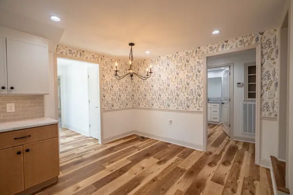 a kitchen with stainless steel appliances granite countertop a refrigerator a stove and a sink