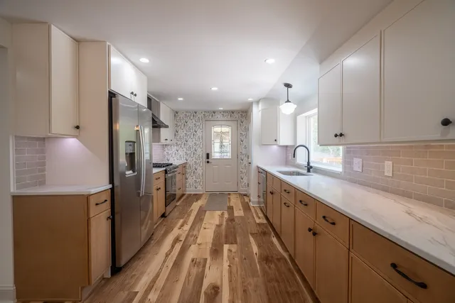 a spacious bathroom with a double vanity sink and a mirror