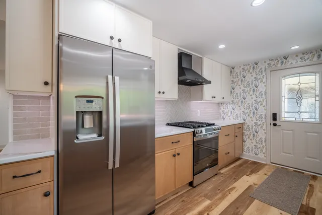 a view of a hallway with wooden floor and stairs