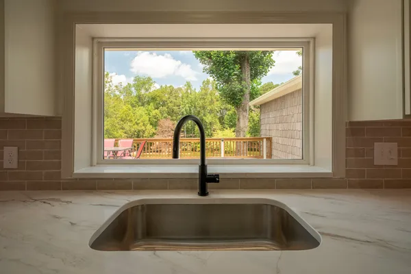 a view of a room with a ceiling fan and a window