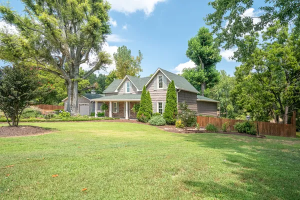 a front view of house with yard and green space