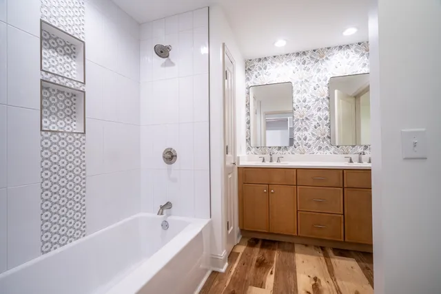 a view of an empty room with window and hardwood floor