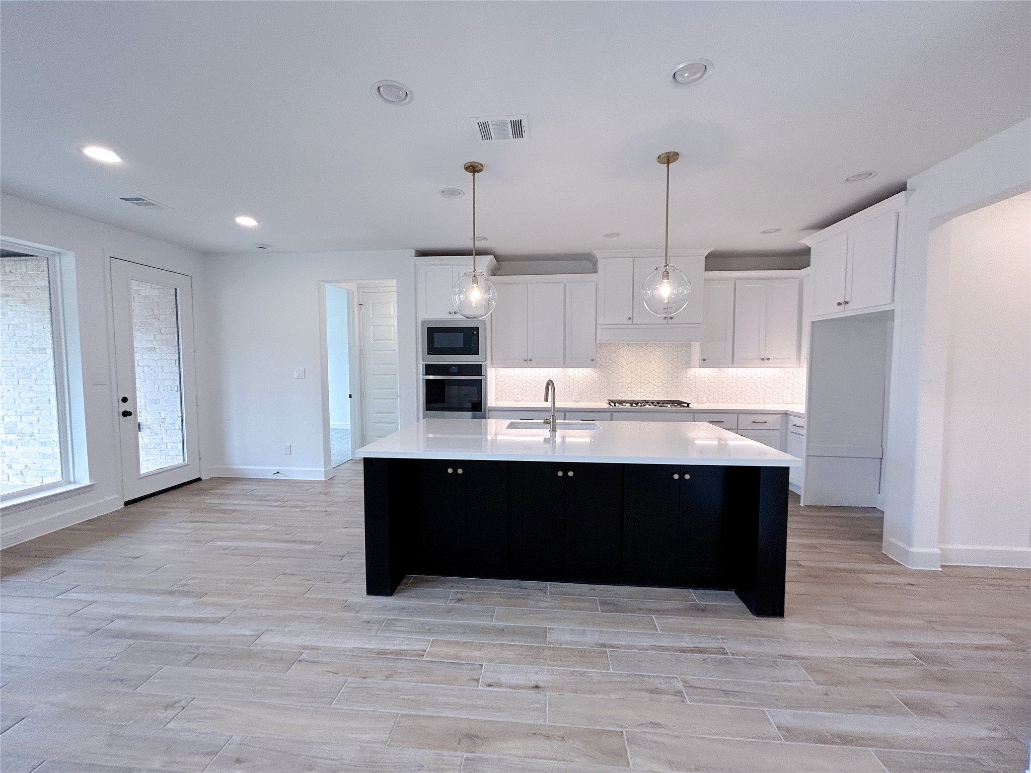 29847 Longleaf Grv Lane Fulshear, TX 77441 - Photo 11 of 39 a view of kitchen with stainless steel appliances granite countertop cabinets and wooden floor