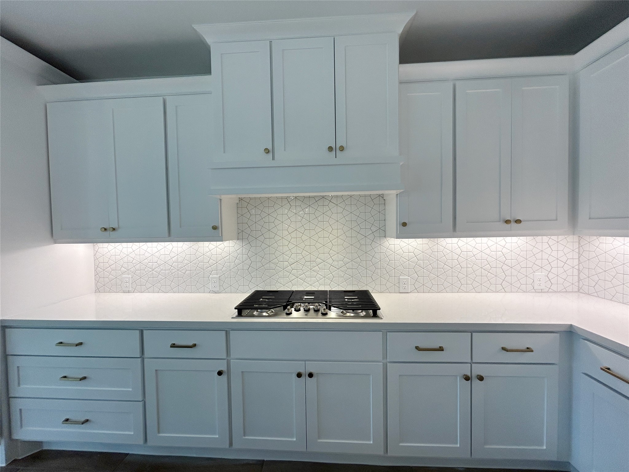 29847 Longleaf Grv Lane Fulshear, TX 77441 - Photo 12 of 39 a kitchen with white cabinets and a stove