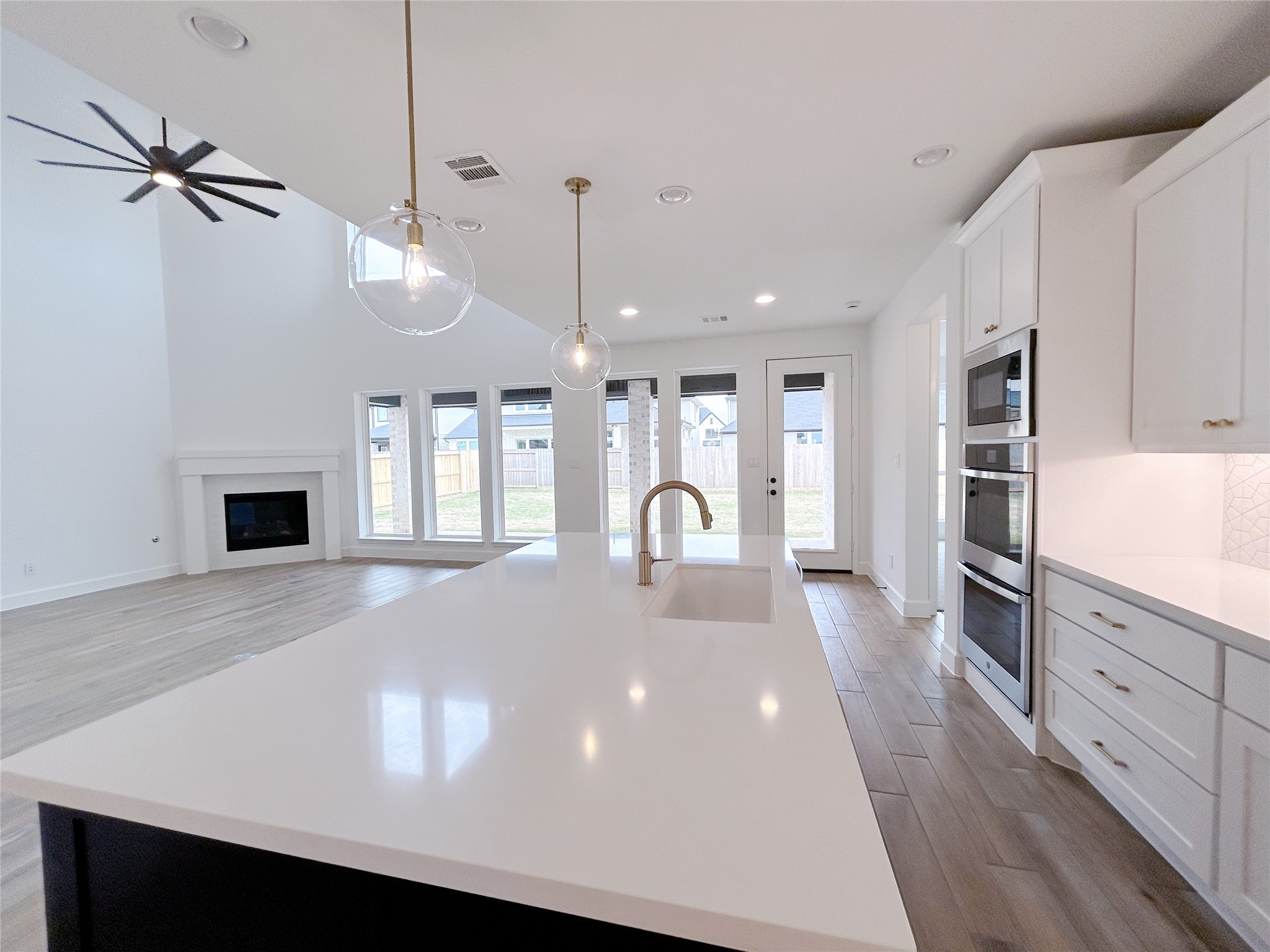 29847 Longleaf Grv Lane Fulshear, TX 77441 - Photo 13 of 39 a large kitchen with stainless steel appliances a large window a oven a sink and a refrigerator