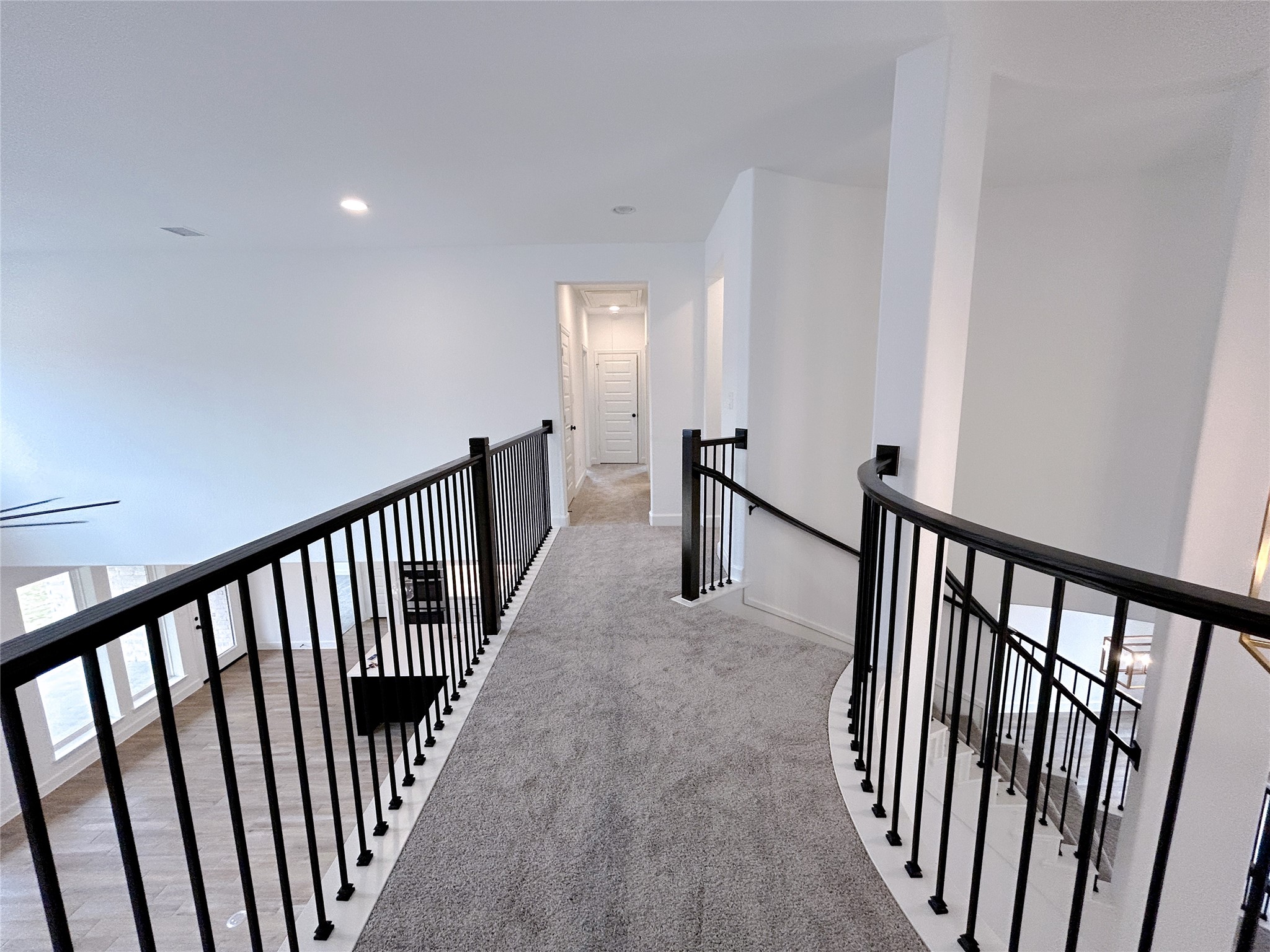 29847 Longleaf Grv Lane Fulshear, TX 77441 - Photo 24 of 39 a view of a hallway with wooden floor and stairs