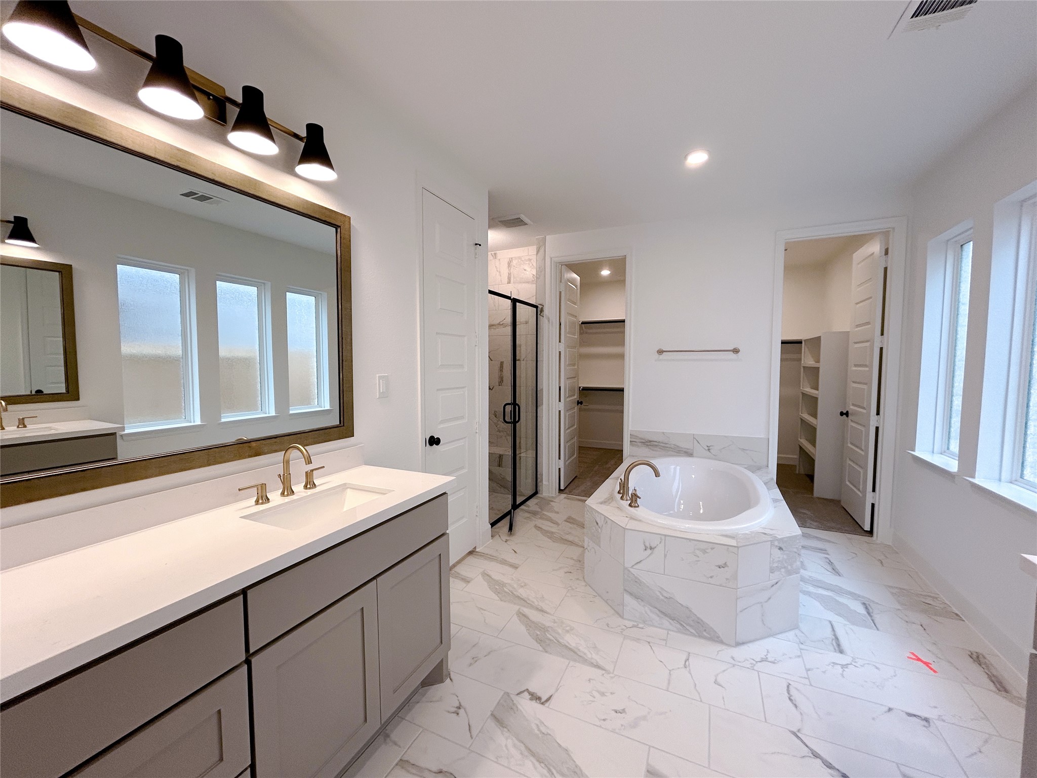 29847 Longleaf Grv Lane Fulshear, TX 77441 - Photo 28 of 39 a spacious bathroom with a double vanity sink and a mirror