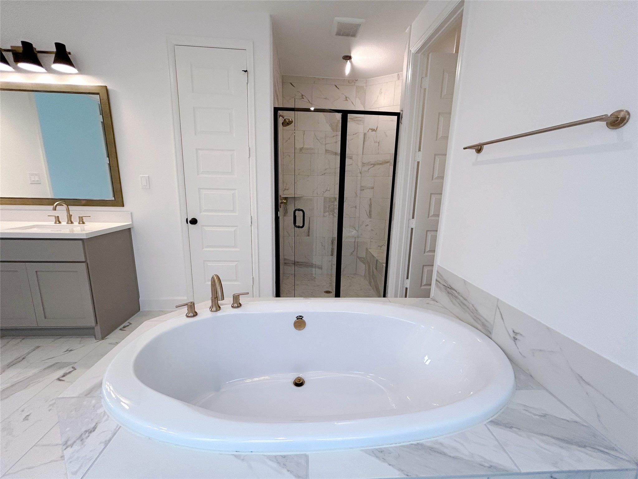 29847 Longleaf Grv Lane Fulshear, TX 77441 - Photo 30 of 39 a bathroom with a bathtub and a sink