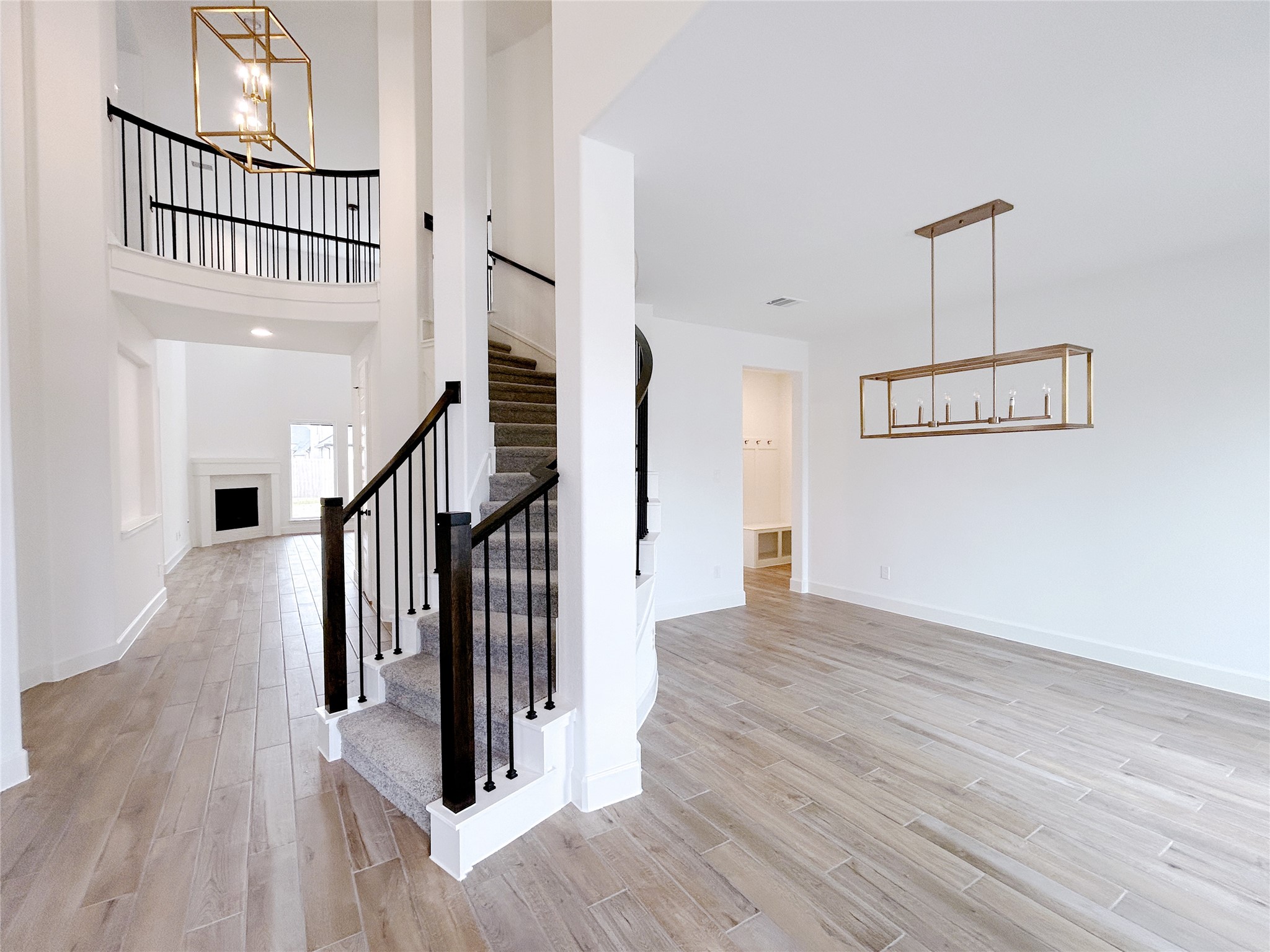 29847 Longleaf Grv Lane Fulshear, TX 77441 - Photo 6 of 39 a view of a hallway with wooden floor and staircase