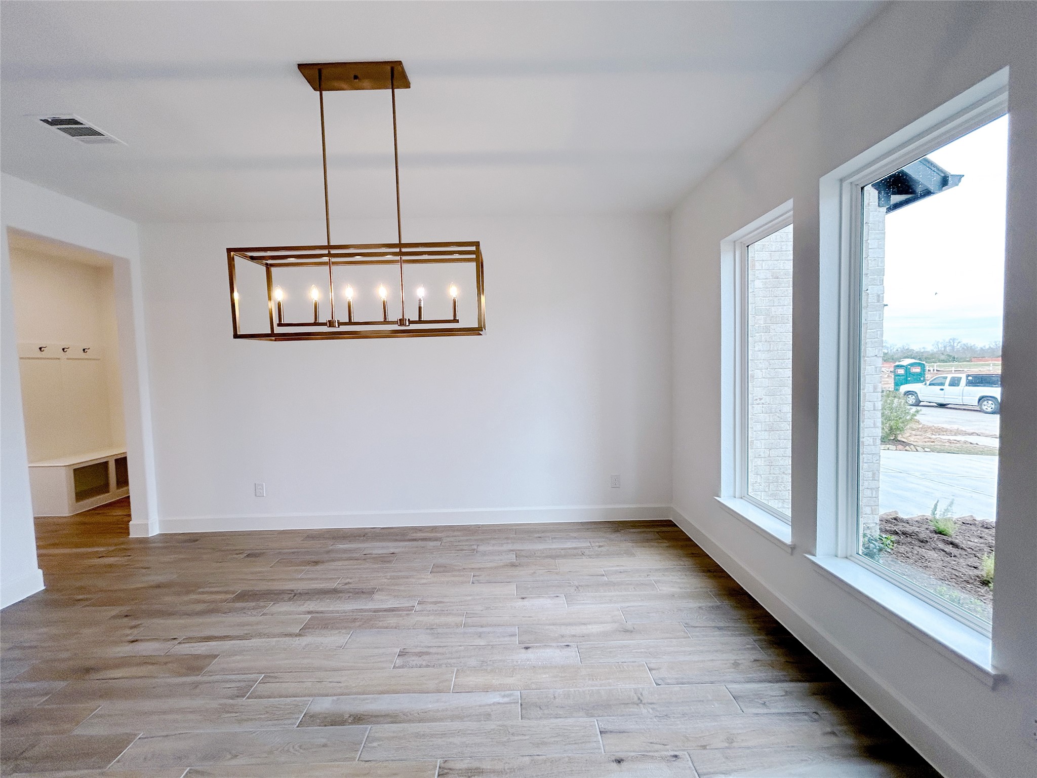29847 Longleaf Grv Lane Fulshear, TX 77441 - Photo 7 of 39 a view of an empty room with a window and wooden floor