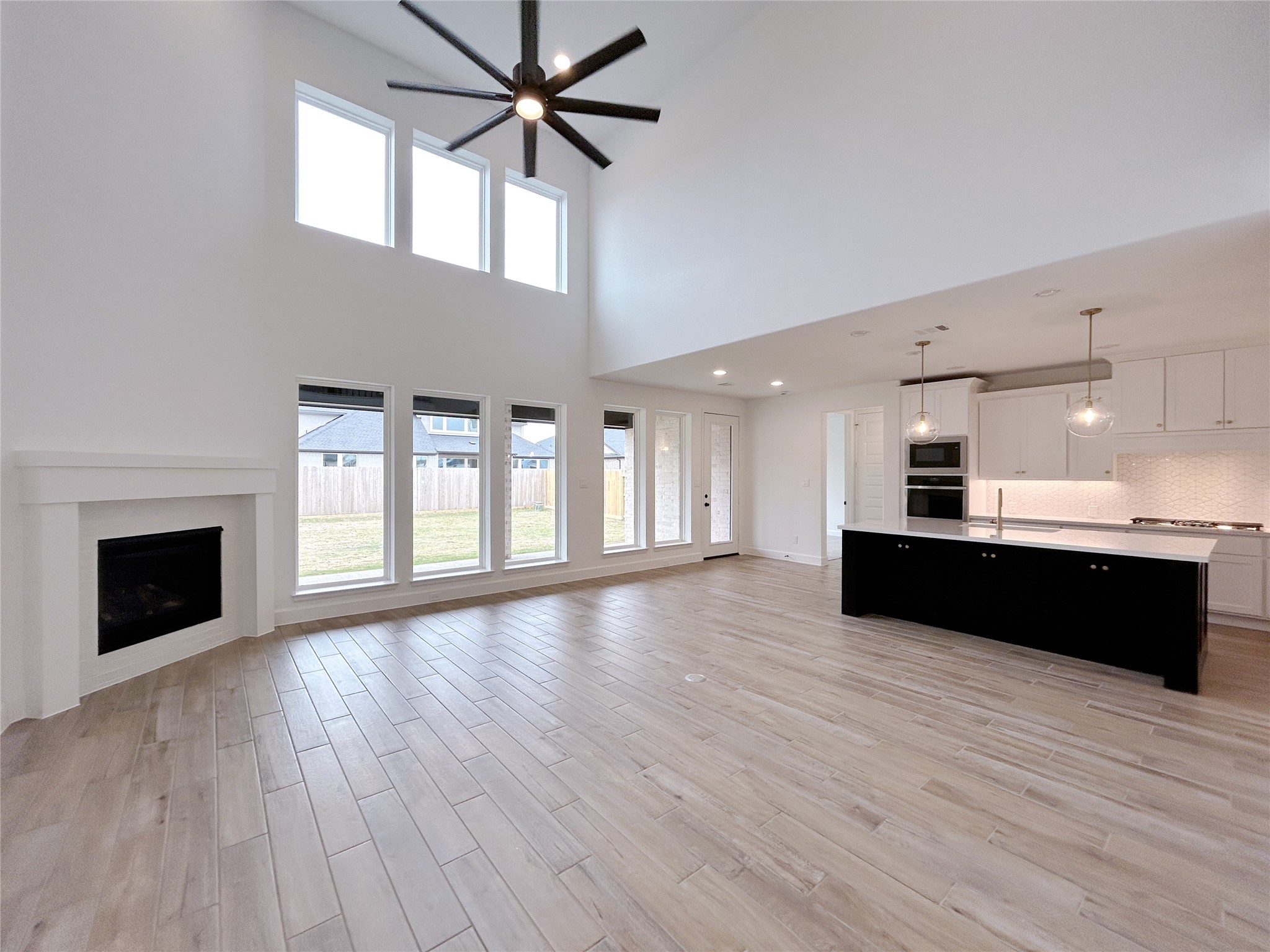 29847 Longleaf Grv Lane Fulshear, TX 77441 - Photo 9 of 39 a living room with hard wood floors and a fireplace