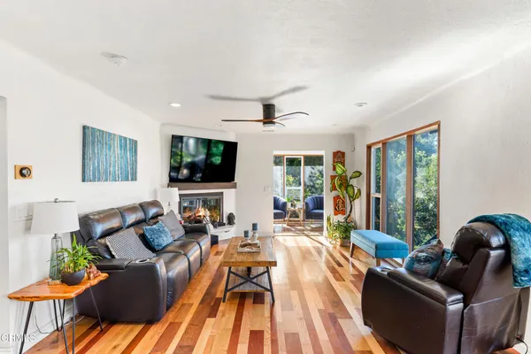a living room with furniture and a wooden floor