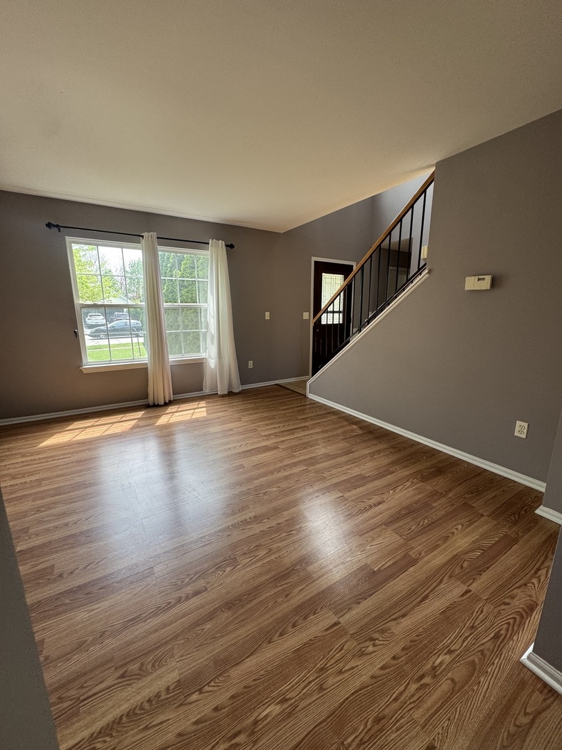 1716 William Drive Romeoville, IL 60446 - Photo 7 of 18 a view of empty room with wooden floor and fan