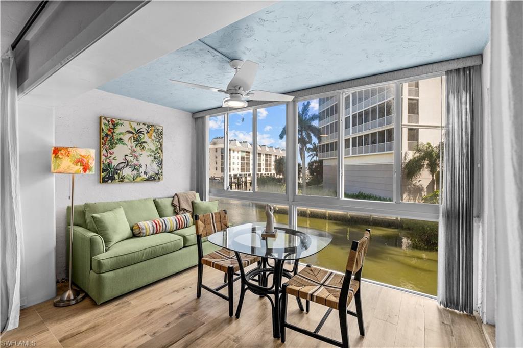 377 Vanderbilt Beach Road, Unit 102 Naples, FL 34108 - Photo 3 of 19 a living room with furniture and a table