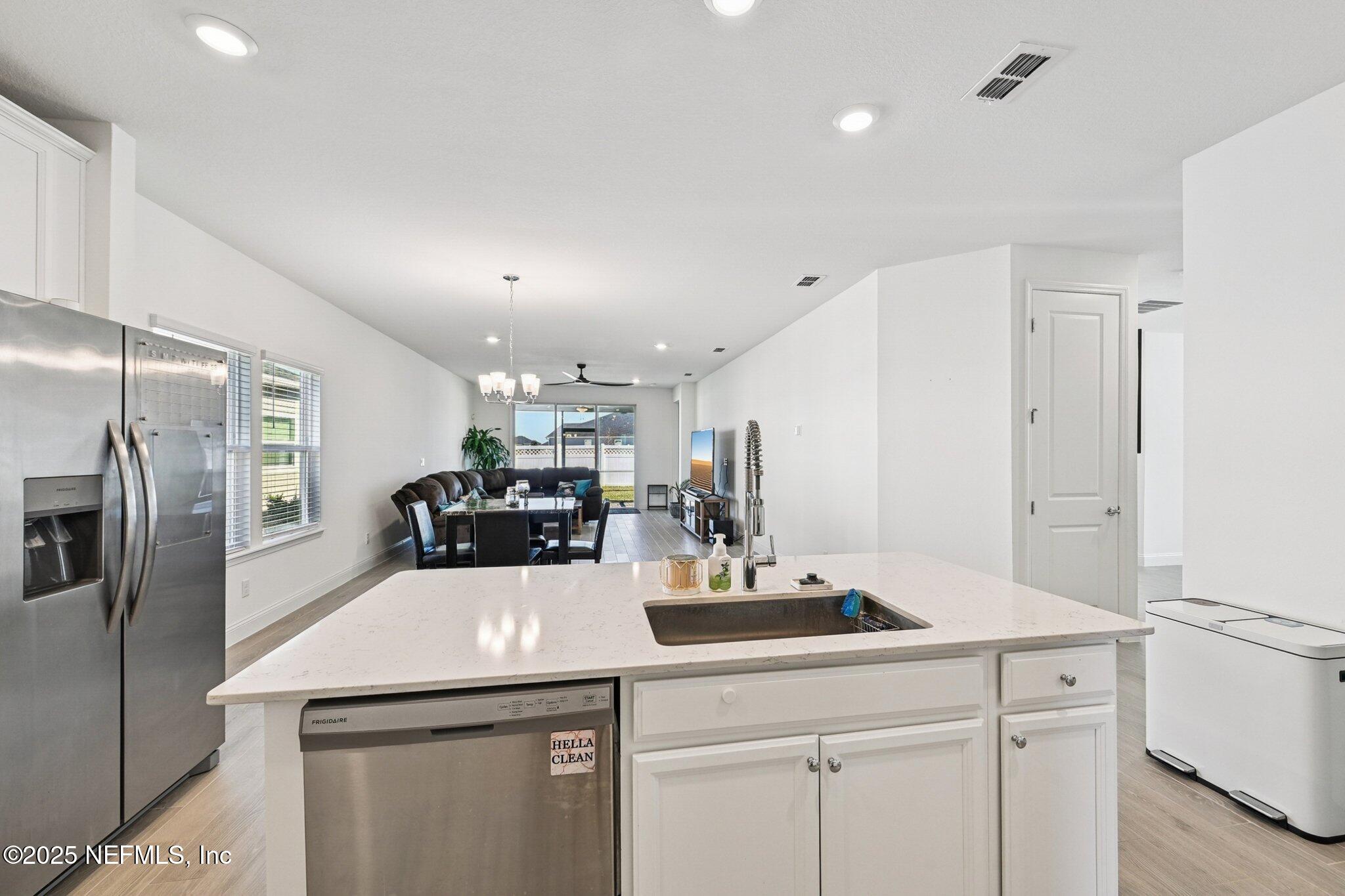 181 Varner Way St. Augustine, FL 32092 - Photo 13 of 27 a kitchen with a sink a refrigerator and cabinets