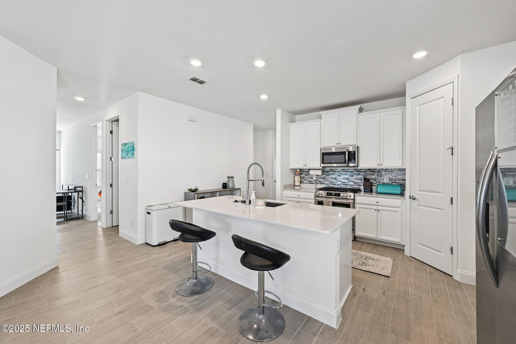 181 Varner Way St. Augustine, FL 32092 - Photo 15 of 27 a kitchen with stainless steel appliances kitchen island granite countertop a refrigerator and a stove top oven