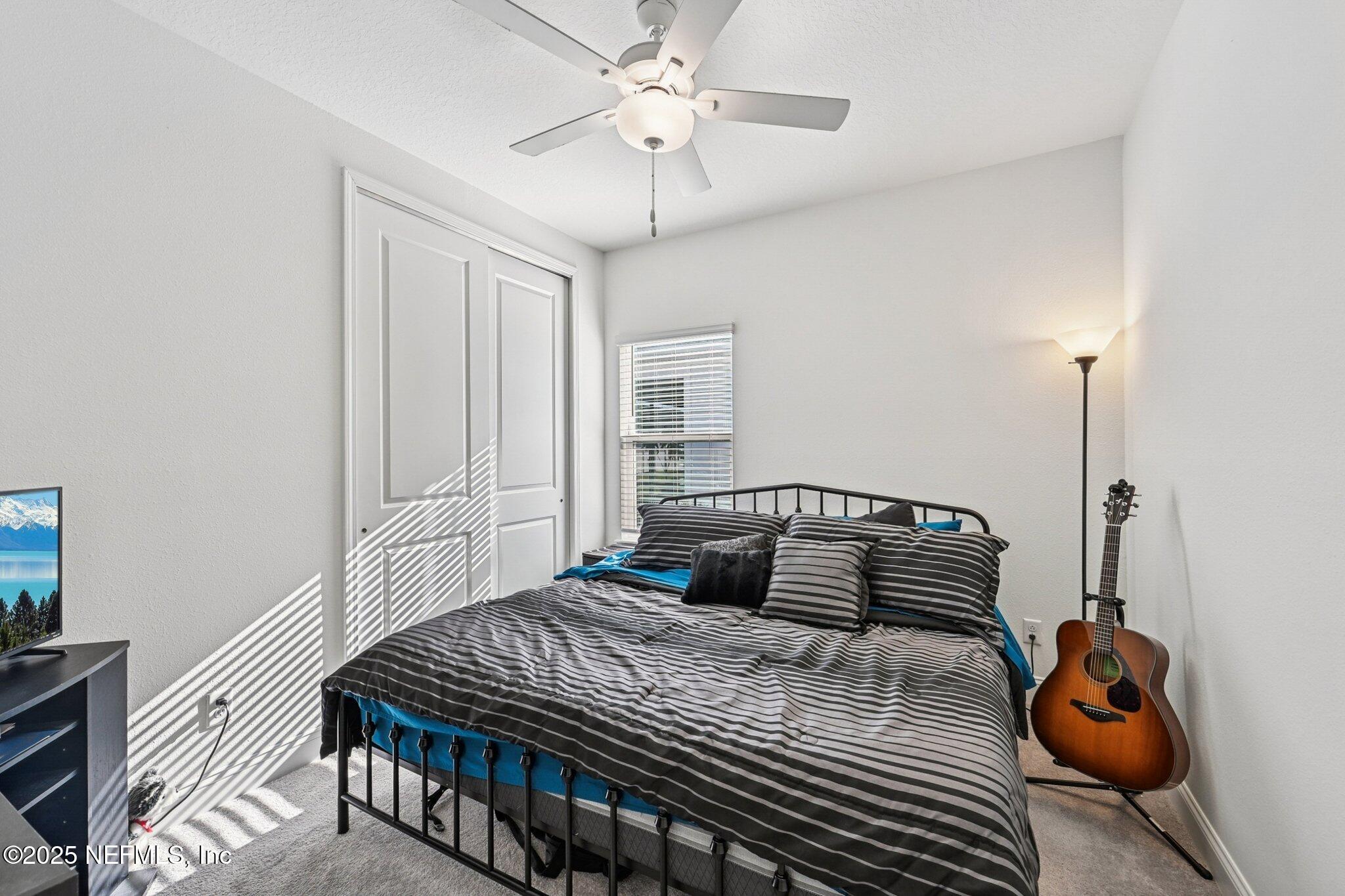 181 Varner Way St. Augustine, FL 32092 - Photo 19 of 27 a bedroom with a bed and a chandelier