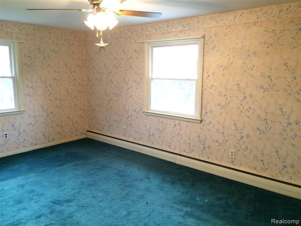 375 Triangle Lake Road Howell, MI 48843 - Photo 15 of 32 Second bedroom with multiple windows and a ceiling fan.