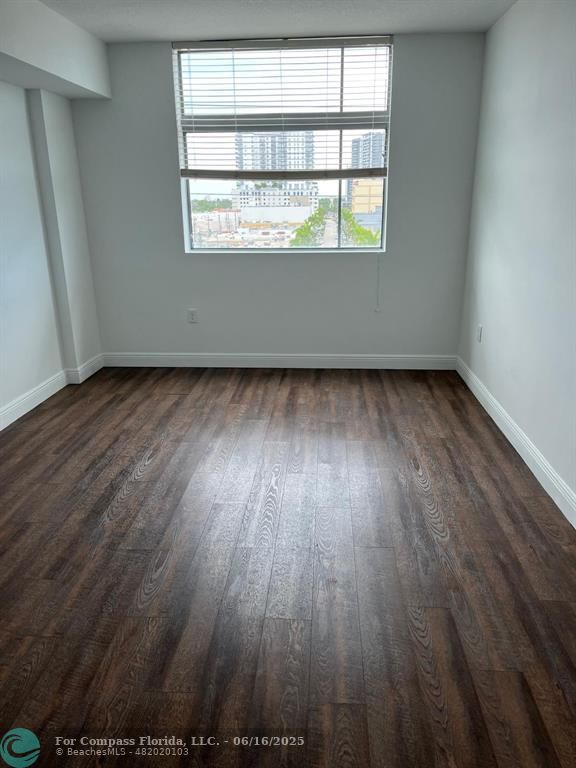 140 South Dixie Highway, Unit 525 Hollywood, FL 33020 - Photo 13 of 16 an empty room with wooden floor and windows