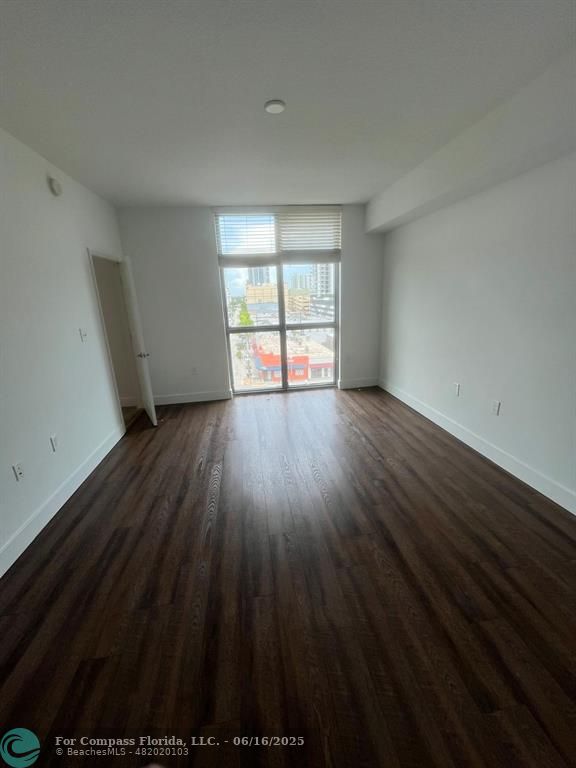 140 South Dixie Highway, Unit 525 Hollywood, FL 33020 - Photo 15 of 16 wooden floor in an empty room with a window