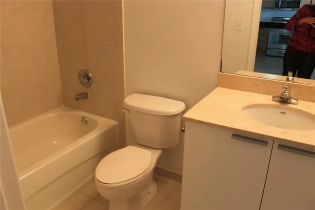 a bathroom with a sink a toilet and bathtub
