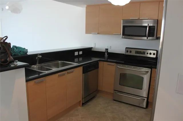 a kitchen with granite countertop a stove and a microwave