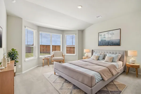 a bedroom with a large bed and a couch