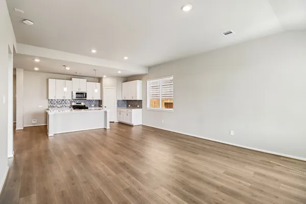 a view of a kitchen with a sink and a refrigerator