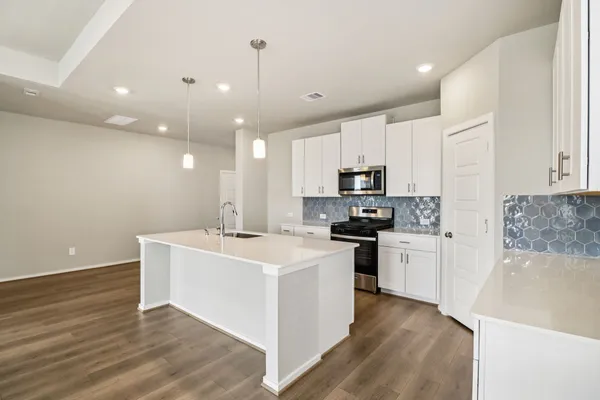 a kitchen with stainless steel appliances a sink stove and refrigerator