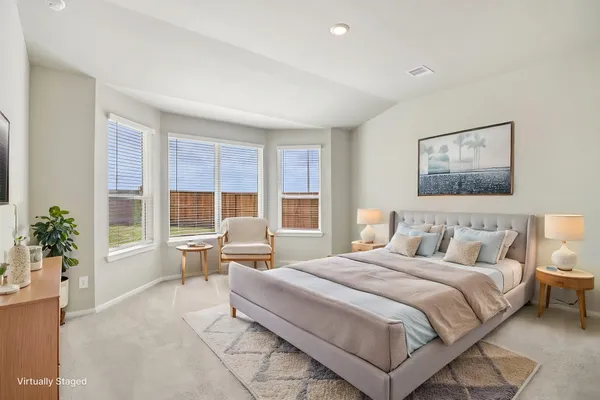 a bedroom with a large bed and a couch