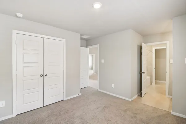 an empty room with closet area