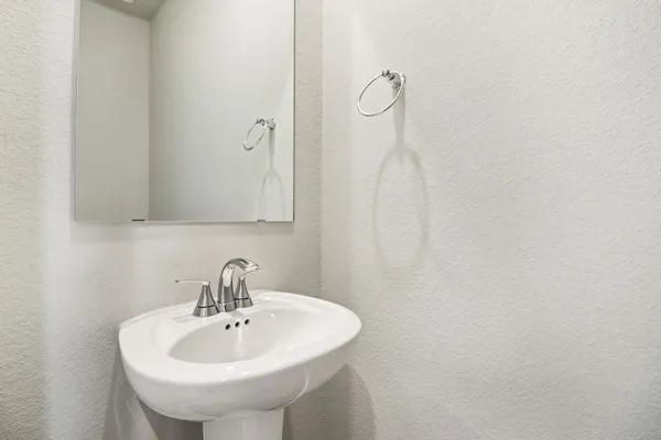 a bathroom with a sink and mirror