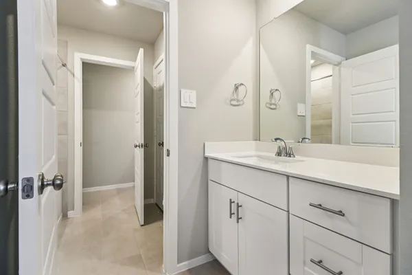 a bathroom with a double vanity sink mirror and shower