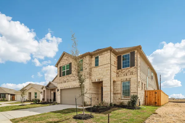 a front view of a residential houses with yard