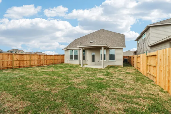 a view of a house with a backyard