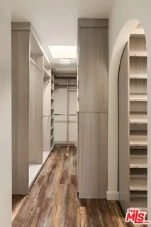 a bedroom with a bed and a mirror