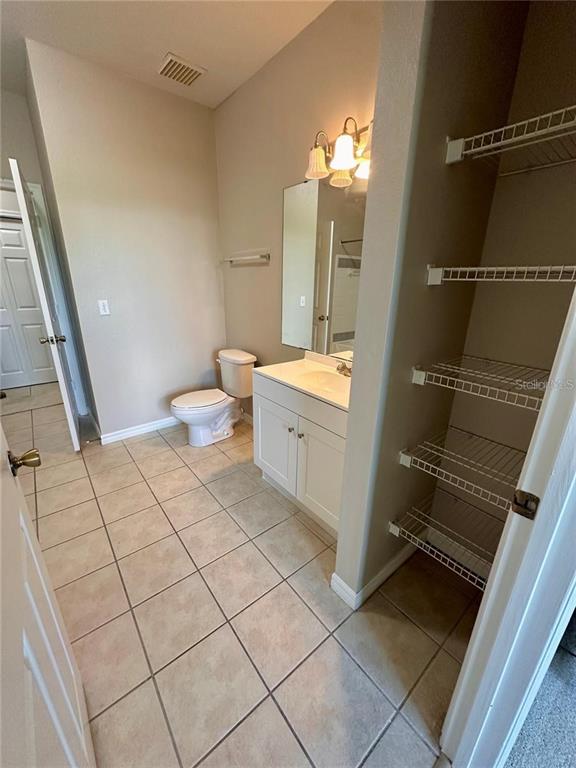 3280 Soho Street, Unit 307 Orlando, FL 32835 - Photo 13 of 34 a bathroom with a sink mirror and toilet