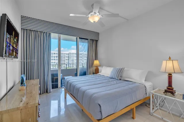 a bedroom with a bed furniture and a large window