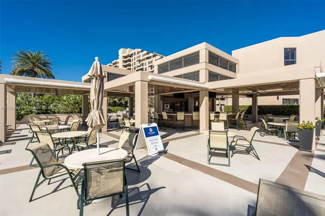 a building outdoor space with patio furniture and potted plants