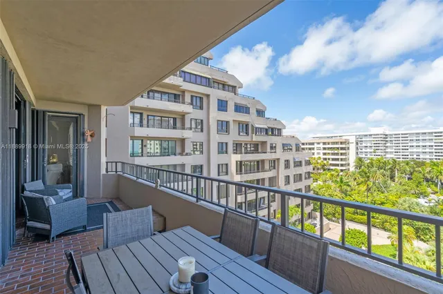 a view of a balcony with wooden floor and outdoor seating
