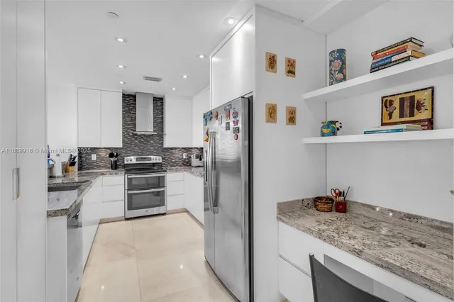 a kitchen with stainless steel appliances granite countertop a refrigerator and a sink