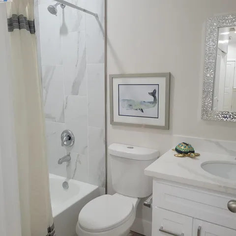 a bathroom with a sink a toilet and bathtub