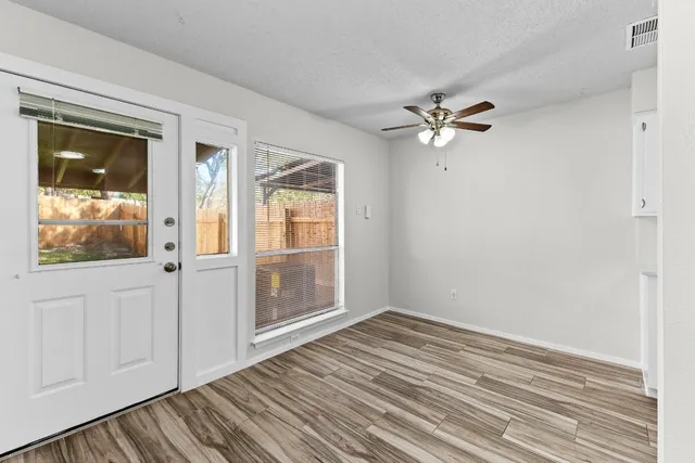 wooden floor in an empty room with a window