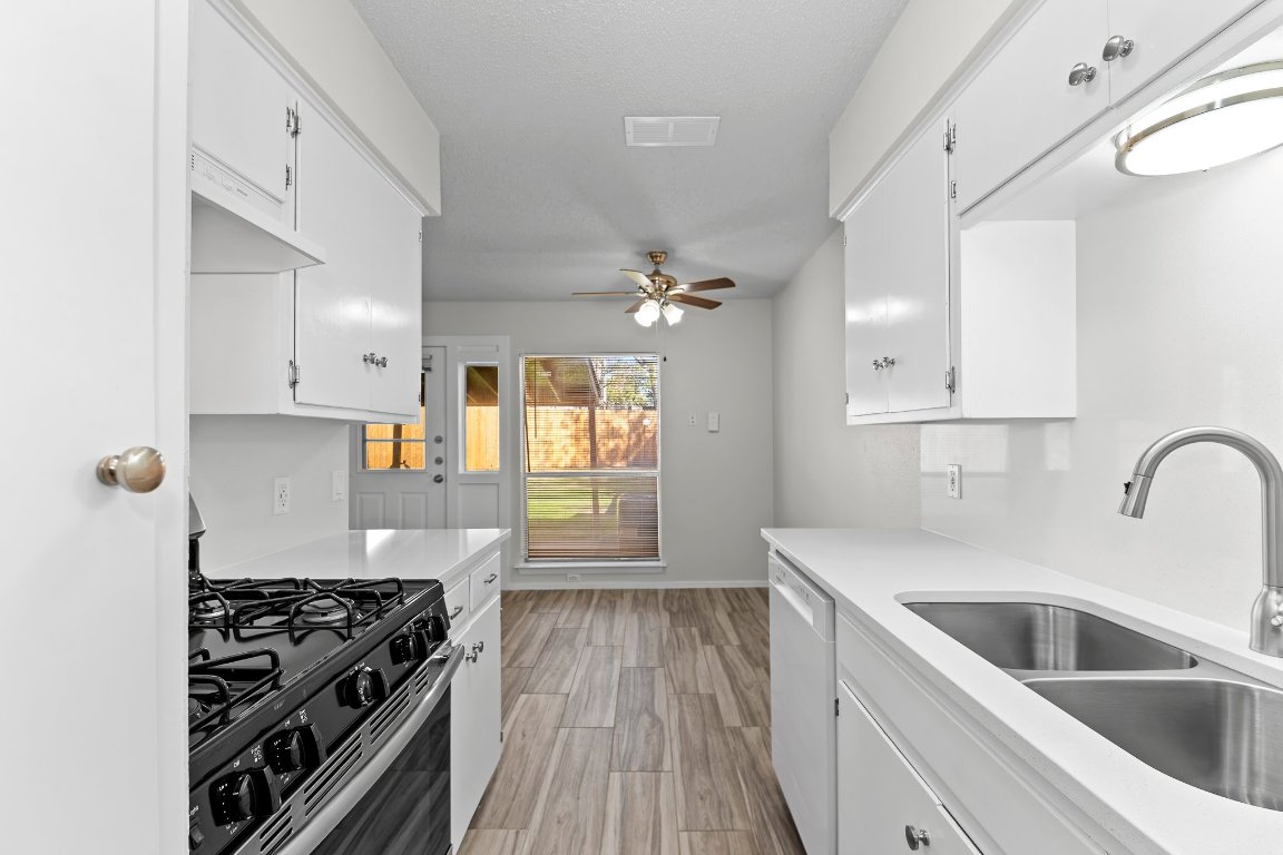 10807 Lambert Circle, Unit A Austin, TX 78758 - Photo 20 of 39 a kitchen with granite countertop a stove and a sink