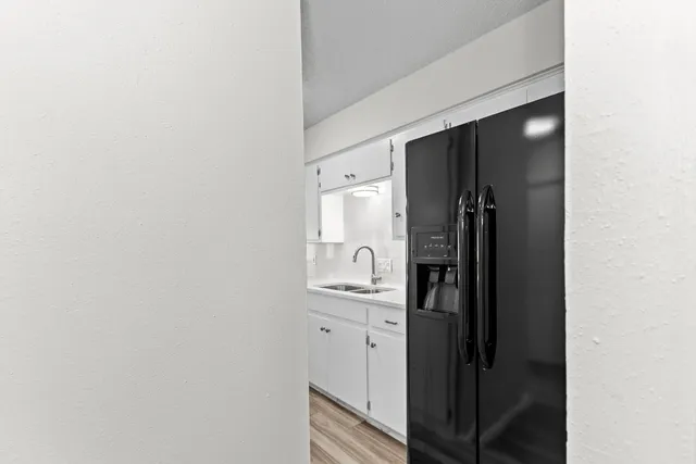 a kitchen with a refrigerator and mirror