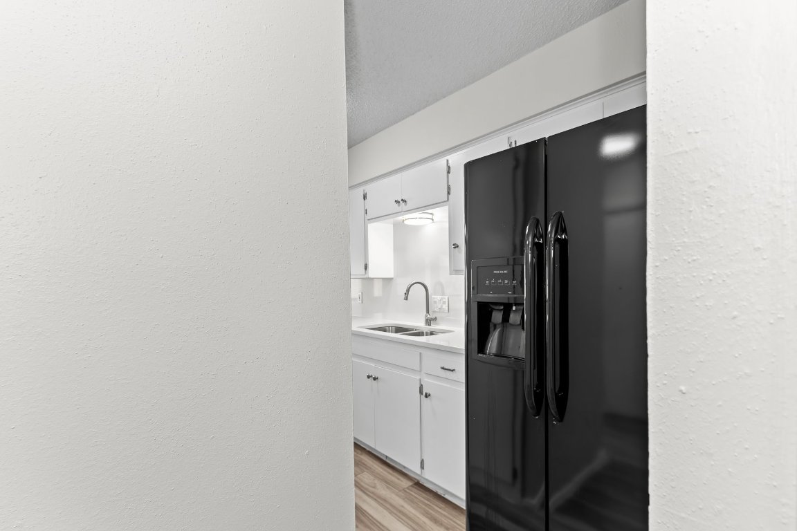 10807 Lambert Circle, Unit A Austin, TX 78758 - Photo 21 of 39 a kitchen with a refrigerator and mirror