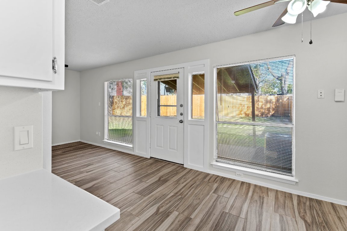 10807 Lambert Circle, Unit A Austin, TX 78758 - Photo 23 of 39 a view of an empty room with wooden floor and a window