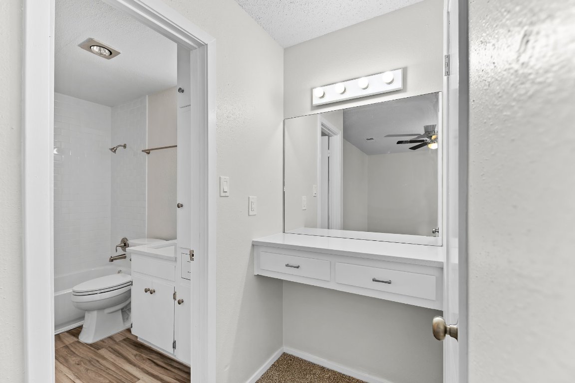10807 Lambert Circle, Unit A Austin, TX 78758 - Photo 31 of 39 a bathroom with a granite countertop sink toilet and shower